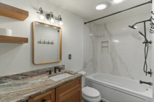 An acrylic bathtub with a porcelain shower surround. Shower remodels don't have to cost an arm and a leg!